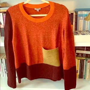 A block pattern sweater with warm colors.